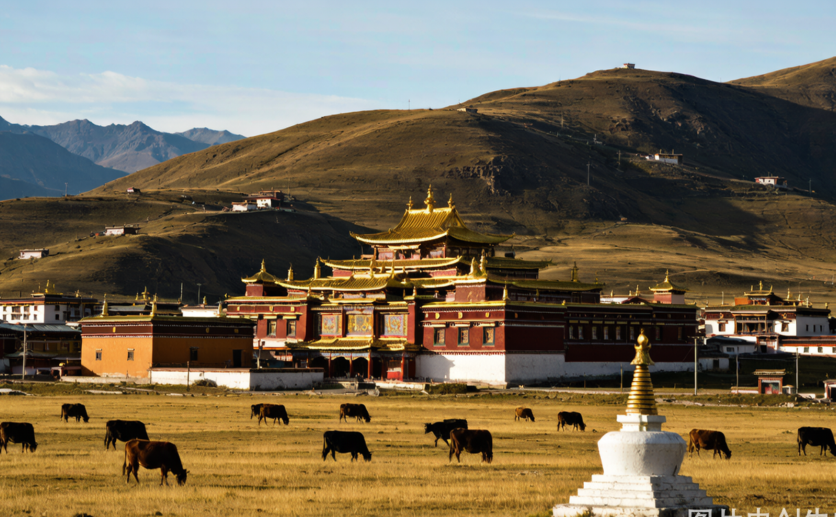 Tibetan pilgrims walking the prayer-flag kora path around Labrang Monastery in Xiahe, Gannan, China