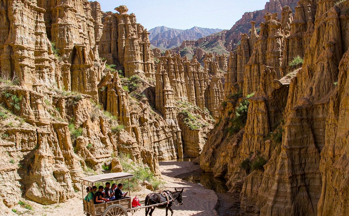 Yellow River Stone Forest sandstone pillars with a donkey cart in the canyon