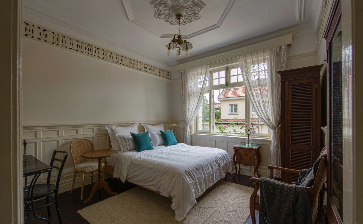 Heritage villa hotel room in the Badaguan district of Qingdao with period furnishings