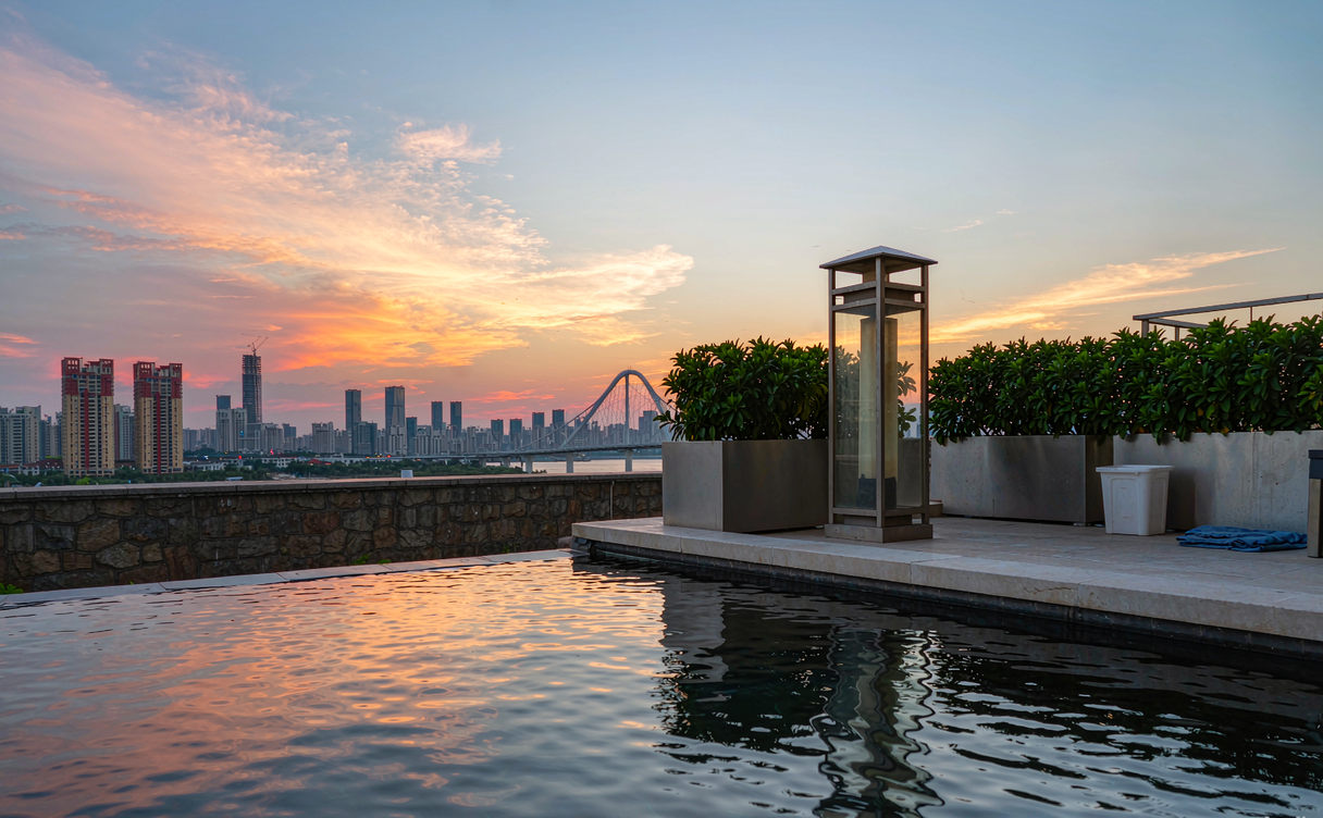 Family pool deck at a Shenzhen resort with the city skyline behind it