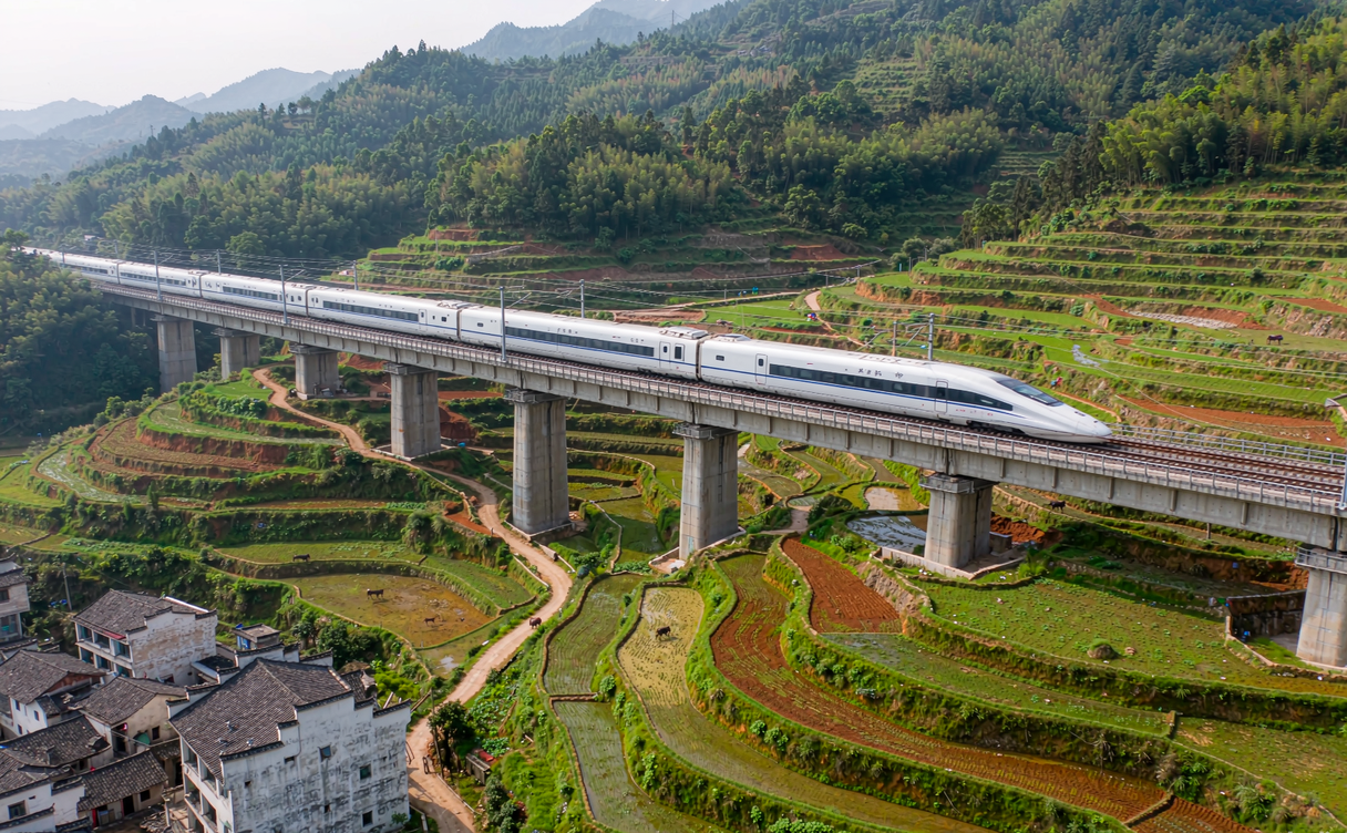train crossing viaduct over rice terraces China