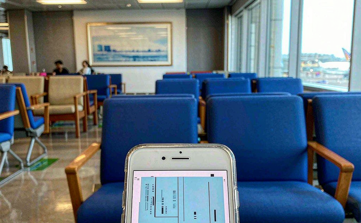Tourist showing a mobile boarding pass at a Chinese airport gate