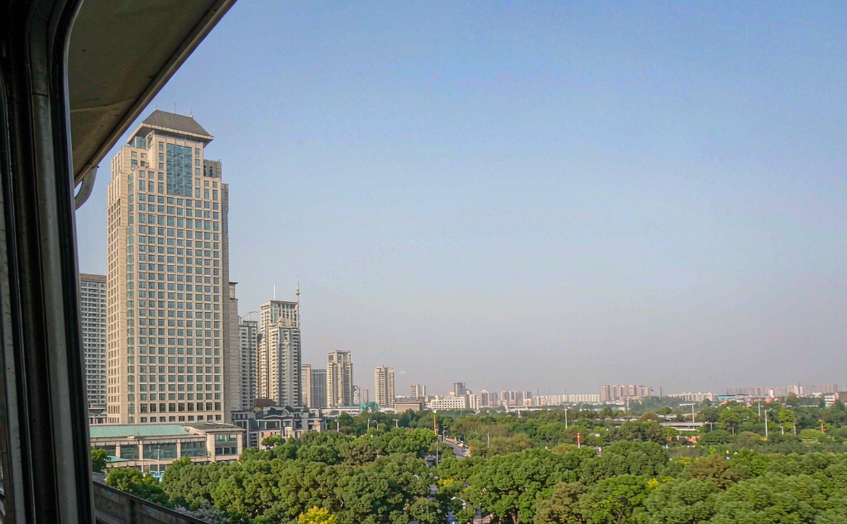 City skyline giving way to countryside on a short high speed rail trip from Beijing