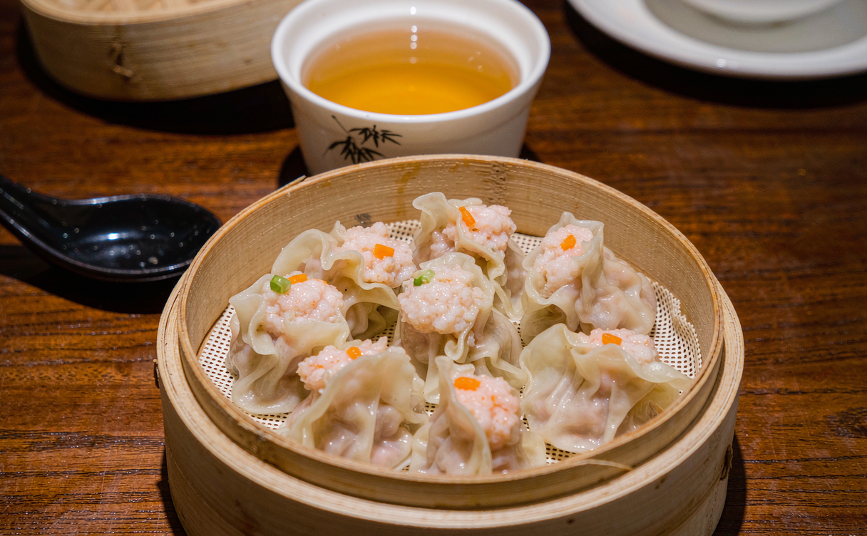 steamed shrimp dumplings with a pot of Chinese tea