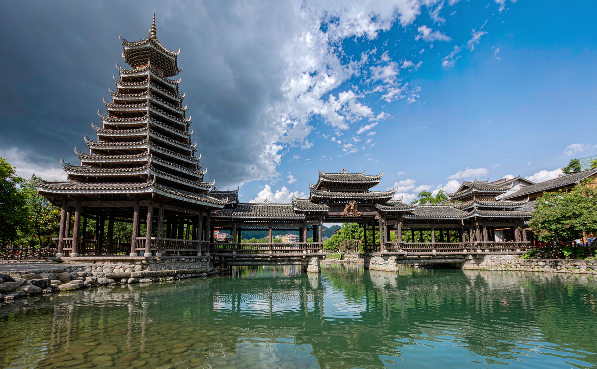 Jiaxiu Tower lit at night over the Nanming River in Guiyang