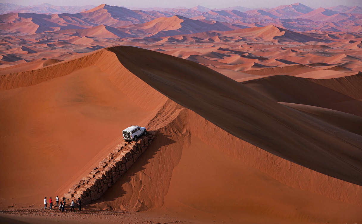 Camels standing on golden sand dunes at Kubuqi Desert in Inner Mongolia