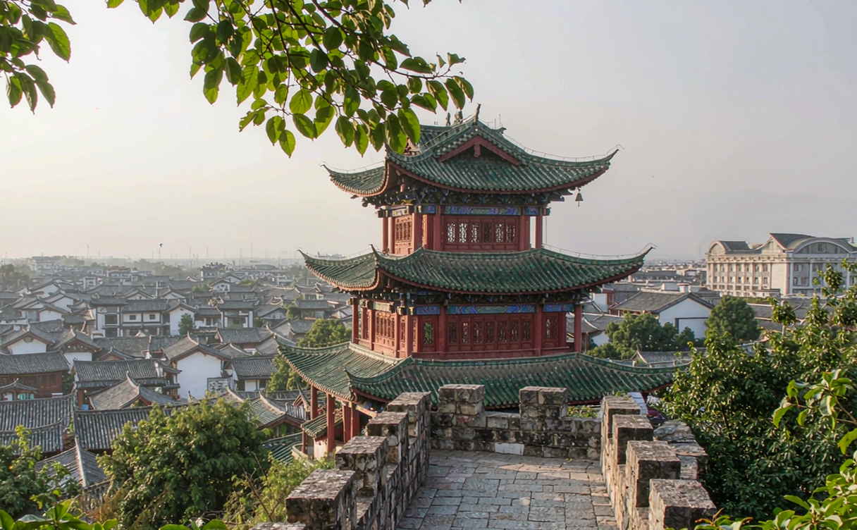 Hilltop pavilion at Mu Residence with a panorama of Lijiang Old Town tiled roofs