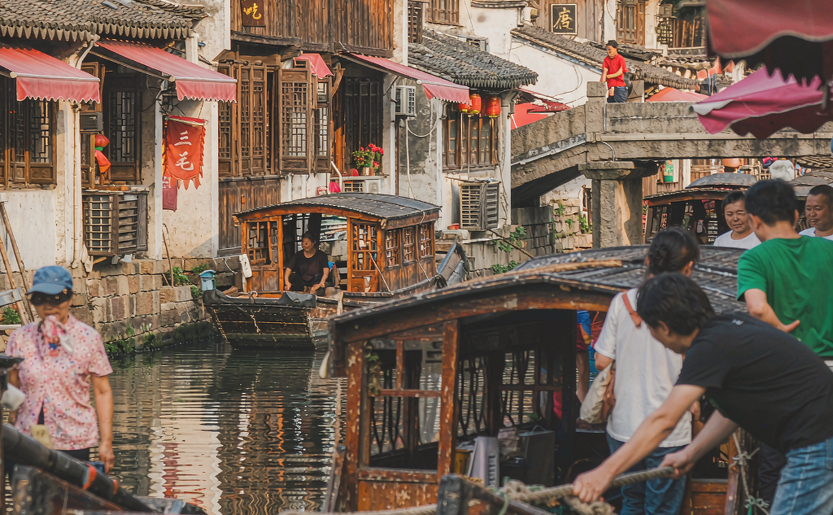 Old timber houses and stone steps along a quiet canal in Luzhi water town