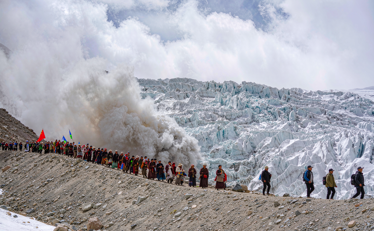 Mingyong Glacier icefall flowing down through pine forest