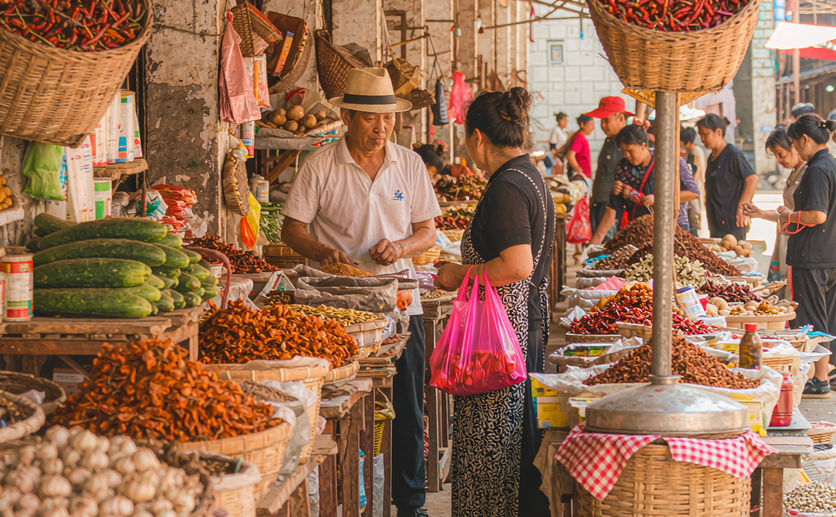 A row of Sichuan snack vendors with red lanterns and displays of dried chili