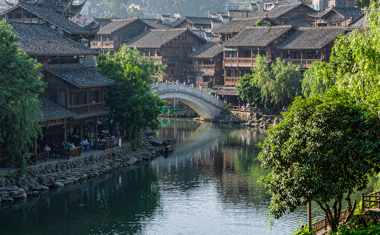 Yaoli ancient town riverside old houses and arched Ming bridge over a clear stream in Jiangxi