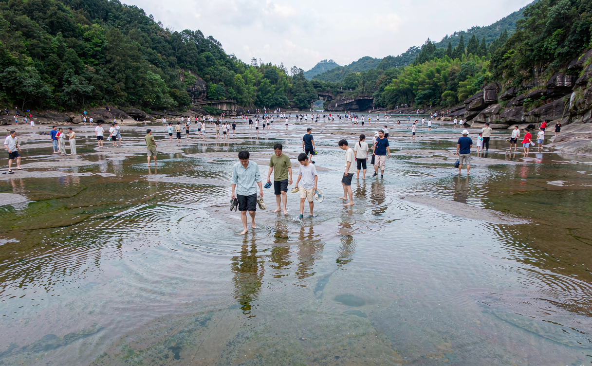 Vast flat river plaza of Baishuiyang Fujian with wading visitors