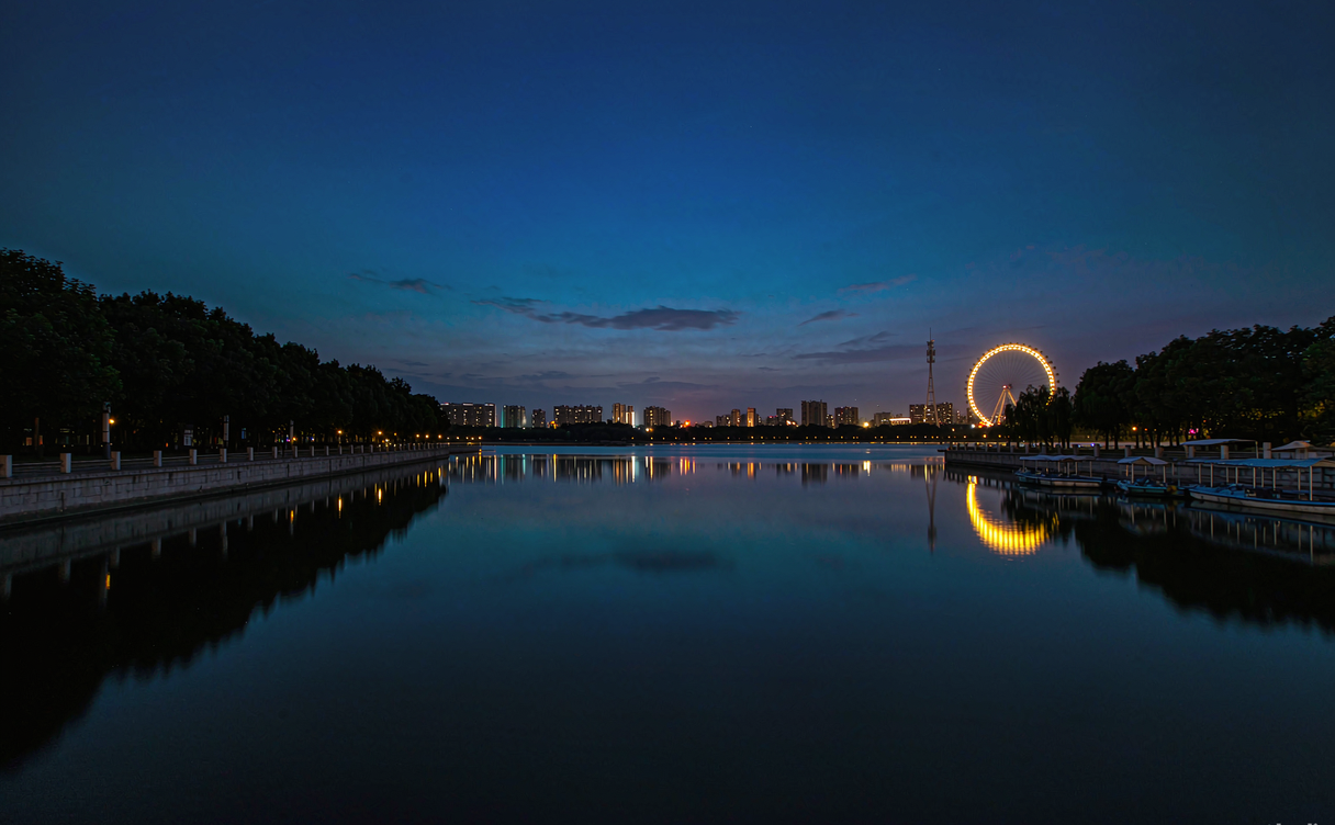 Bengbu Longzi Lake park with promenade and Ferris wheel at night