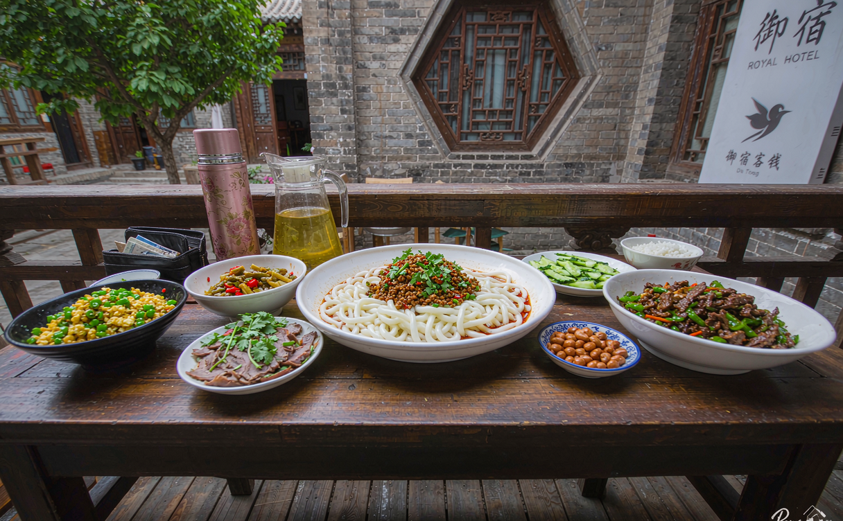 Courtyard hotel breakfast table set with local Datong noodle bowls and tea in the morning