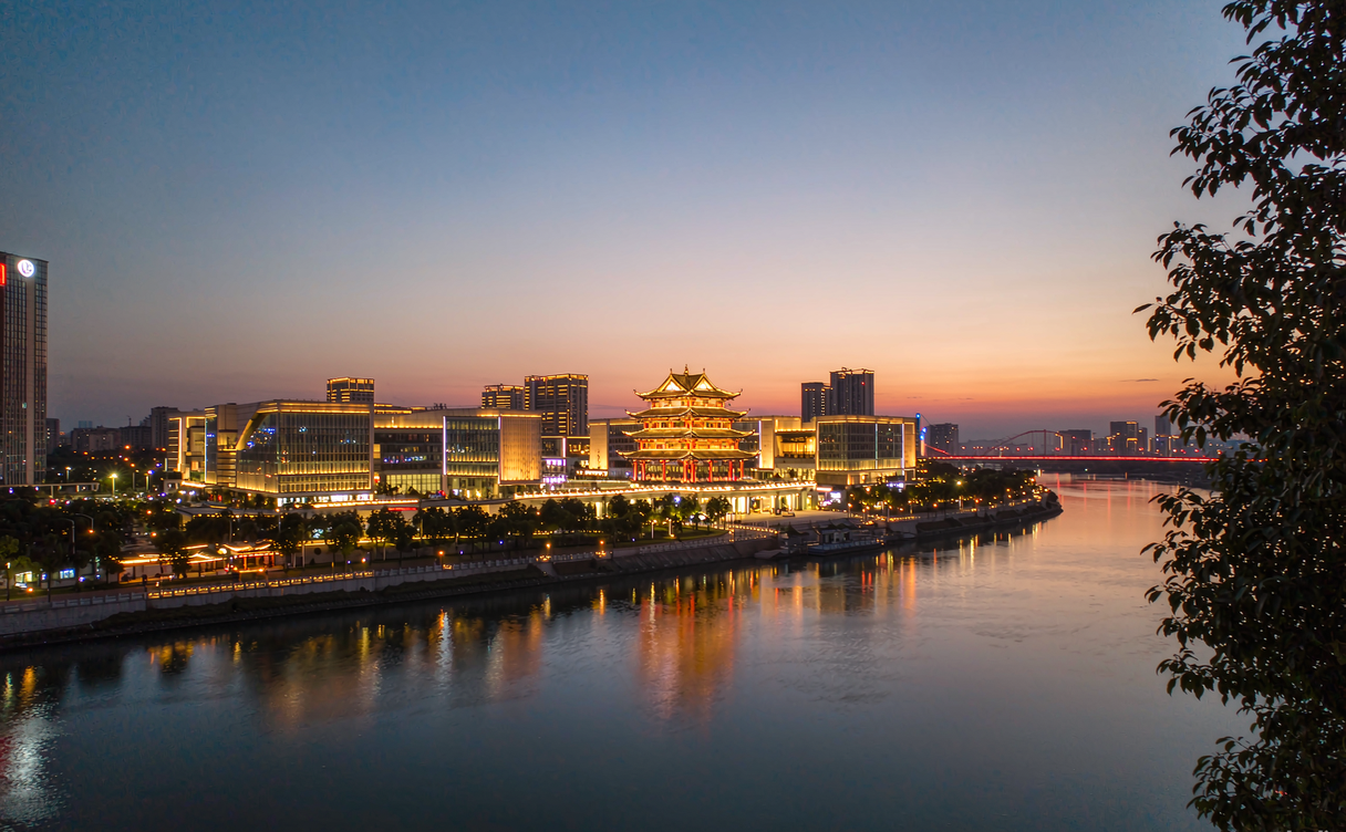 Tengwang Pavilion lit at night reflected in the Ganjiang River