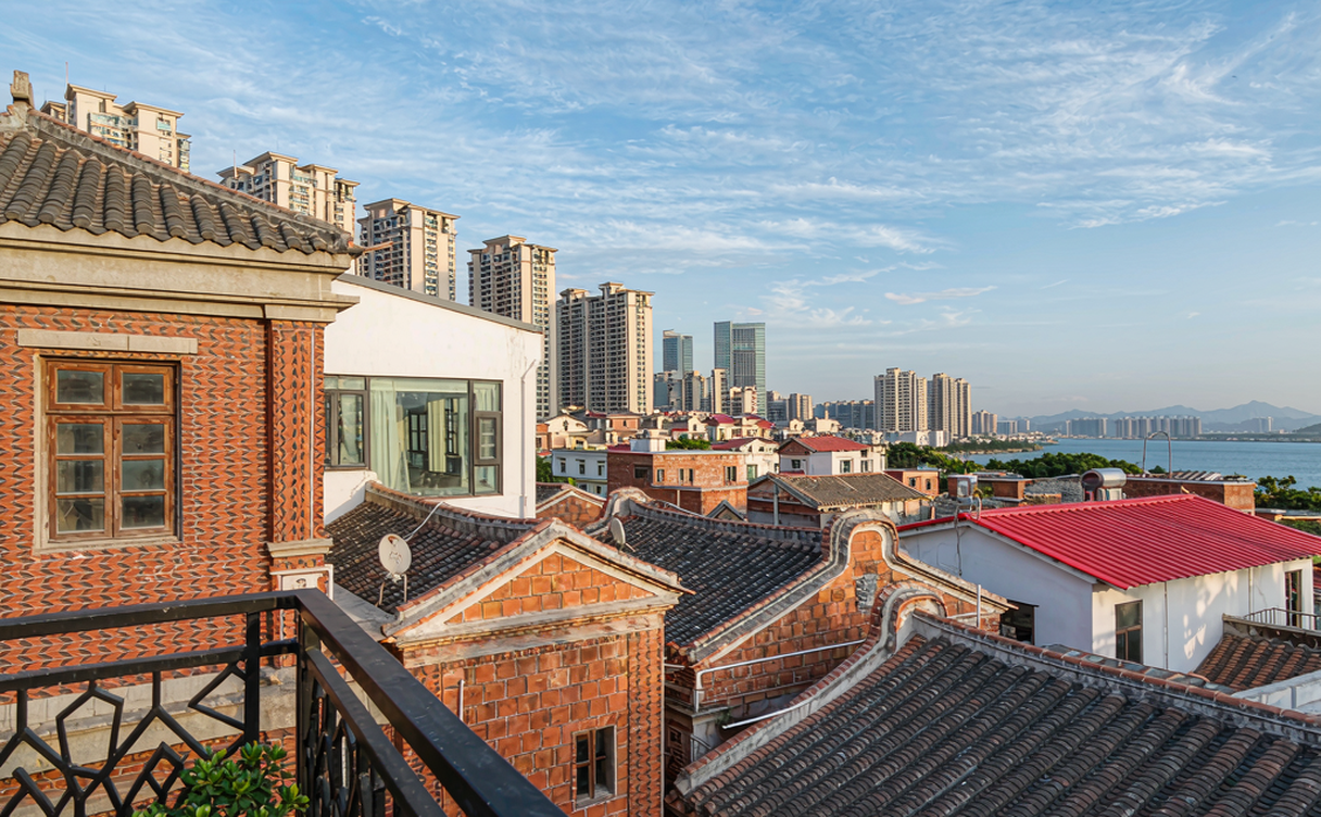 A rooftop terrace lounge overlooking Quanzhou's historic city skyline at dusk, Fujian, China