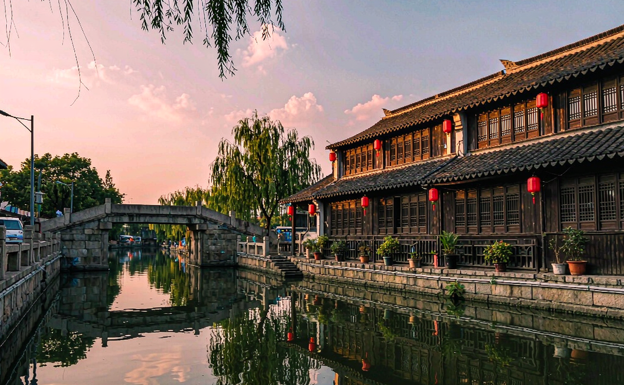 Cozy room opening to a Shaoxing water-town alley scene
