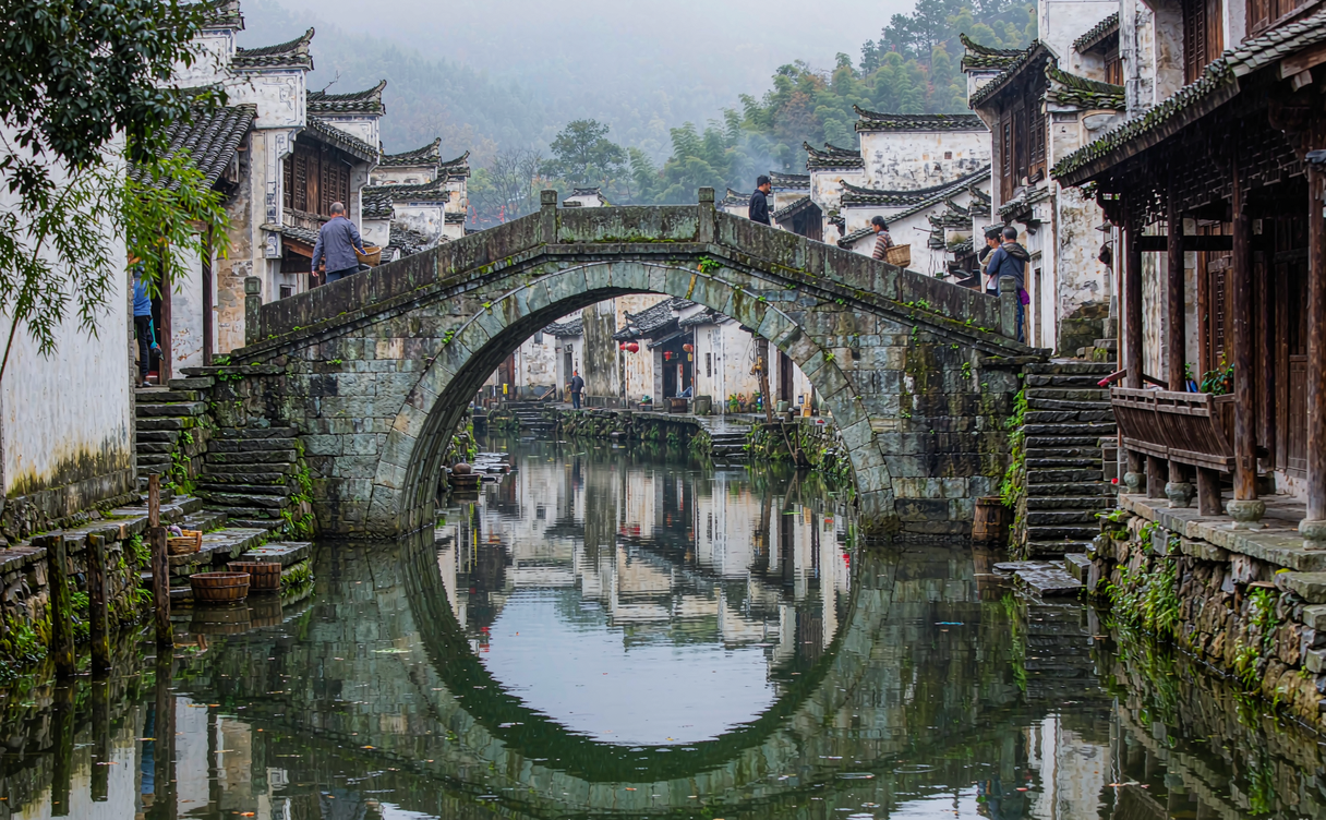 Arched stone bridge and quiet canal through Chaji village Anhui
