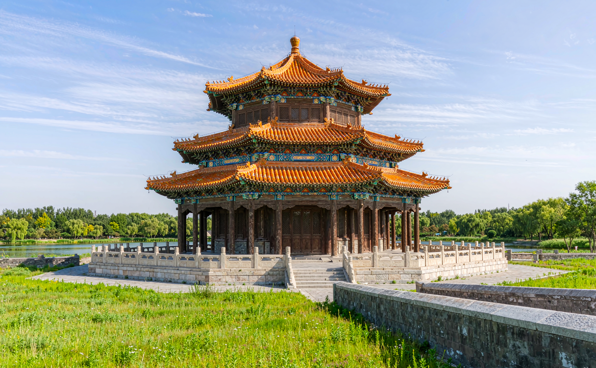 Wooden pavilions and arched bridges reflected in the calm lake of Chengde Mountain Resort, China
