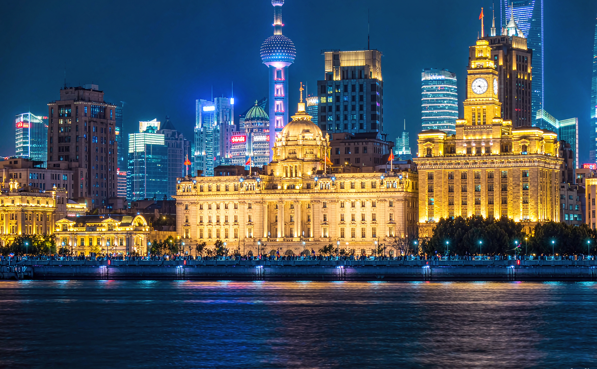 Shanghai's historic Bund waterfront lit up at night facing the modern Lujiazui towers