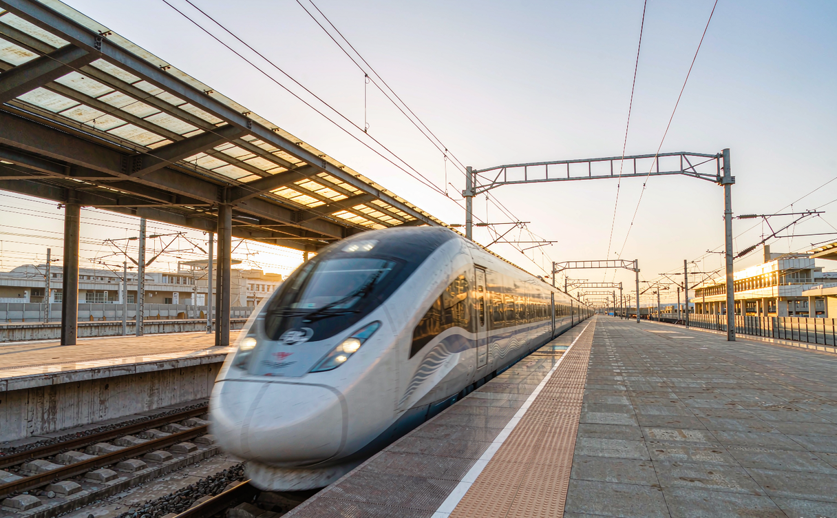 A Chinese high-speed train at a station platform on a clear day