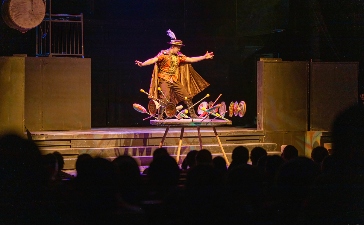 Chinese acrobats performing a human pyramid under spotlights