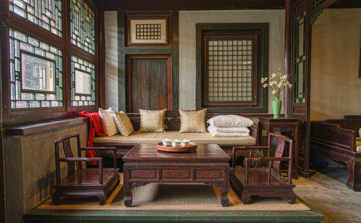 Traditional Beijing siheyuan courtyard lit by lanterns at night