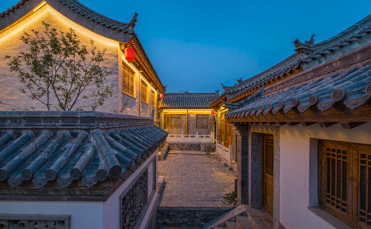 Lattice door opening to a planted Chinese courtyard