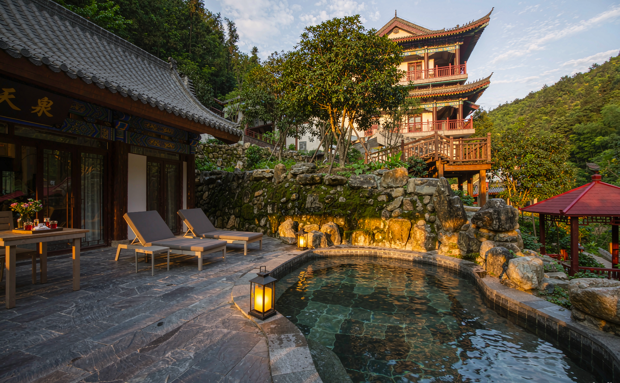 Private wooden hot spring tub inside a Chinese resort room with steam rising