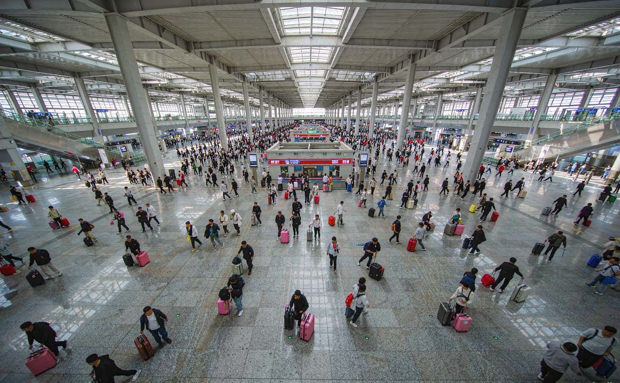 Busy railway station concourse in China during a holiday
