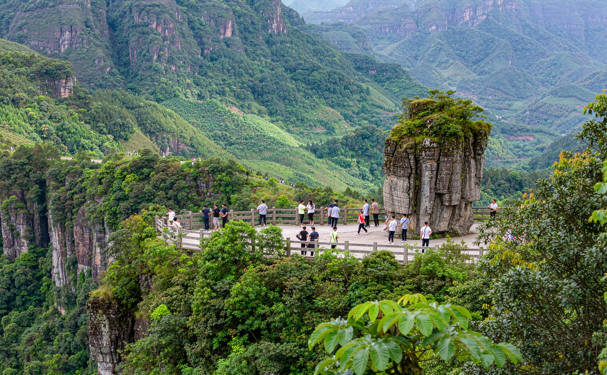 Travelers at a scenic overlook keeping distance from the main crowd