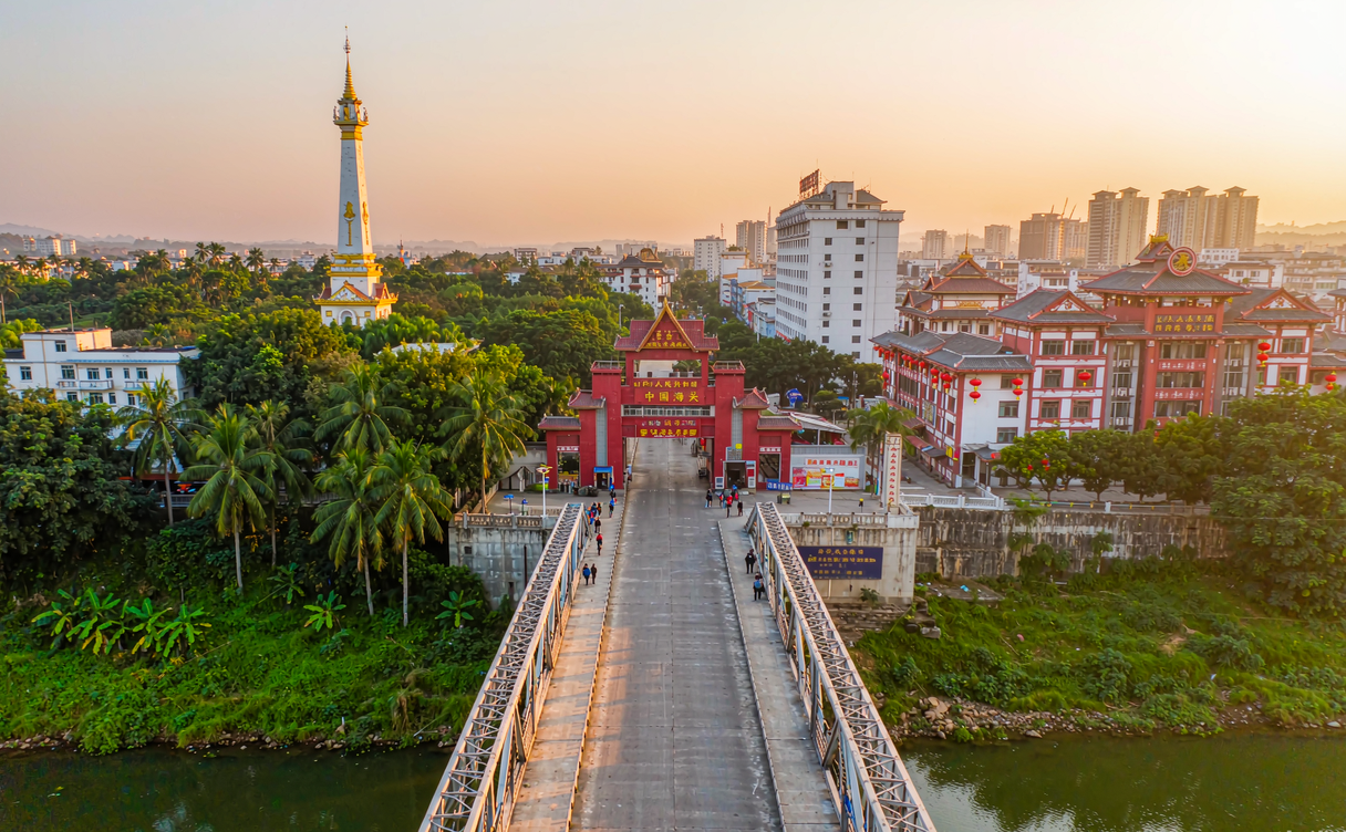 Modern China land border crossing bridge with customs halls on both sides at dawn