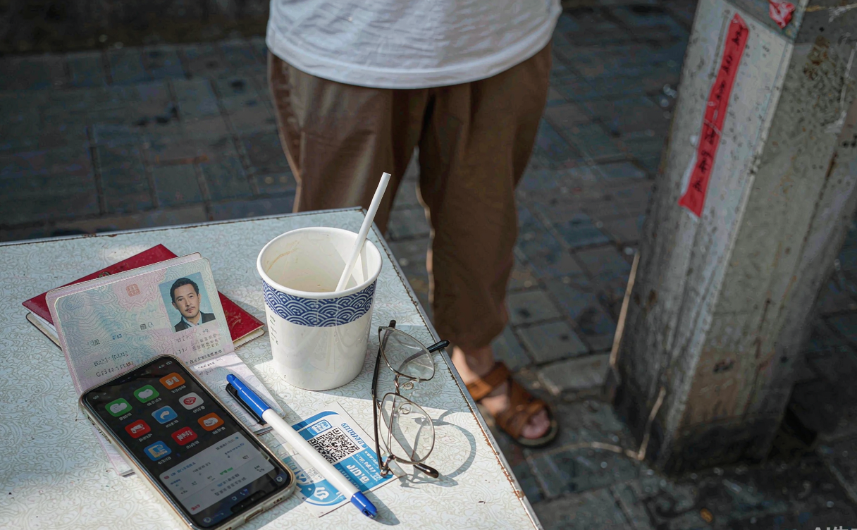 Passport, boarding pass and smartphone displaying China travel apps on a table