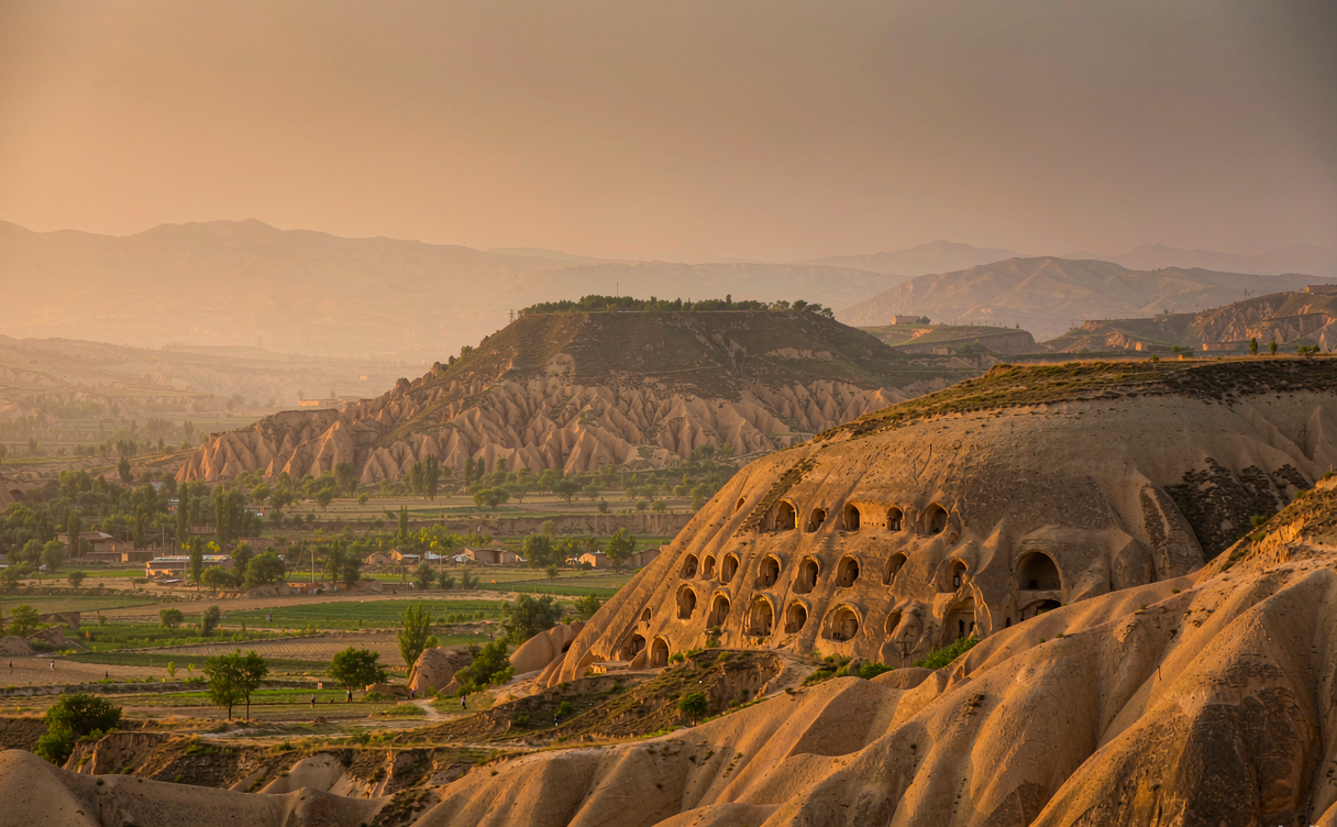Loess plateau hills with cave dwellings near Yan'an at dusk