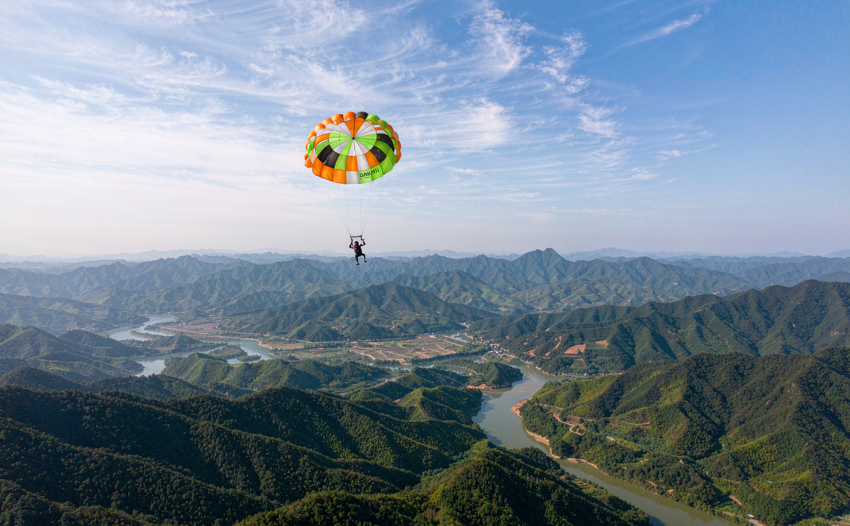 Tandem skydiver free-falling over Hainan tropical coastline