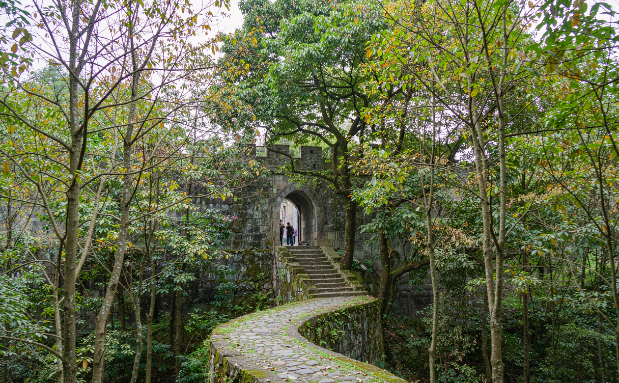 Ancient stone fortress walls of Diaoyucheng on a cliff above a river confluence near Chongqing