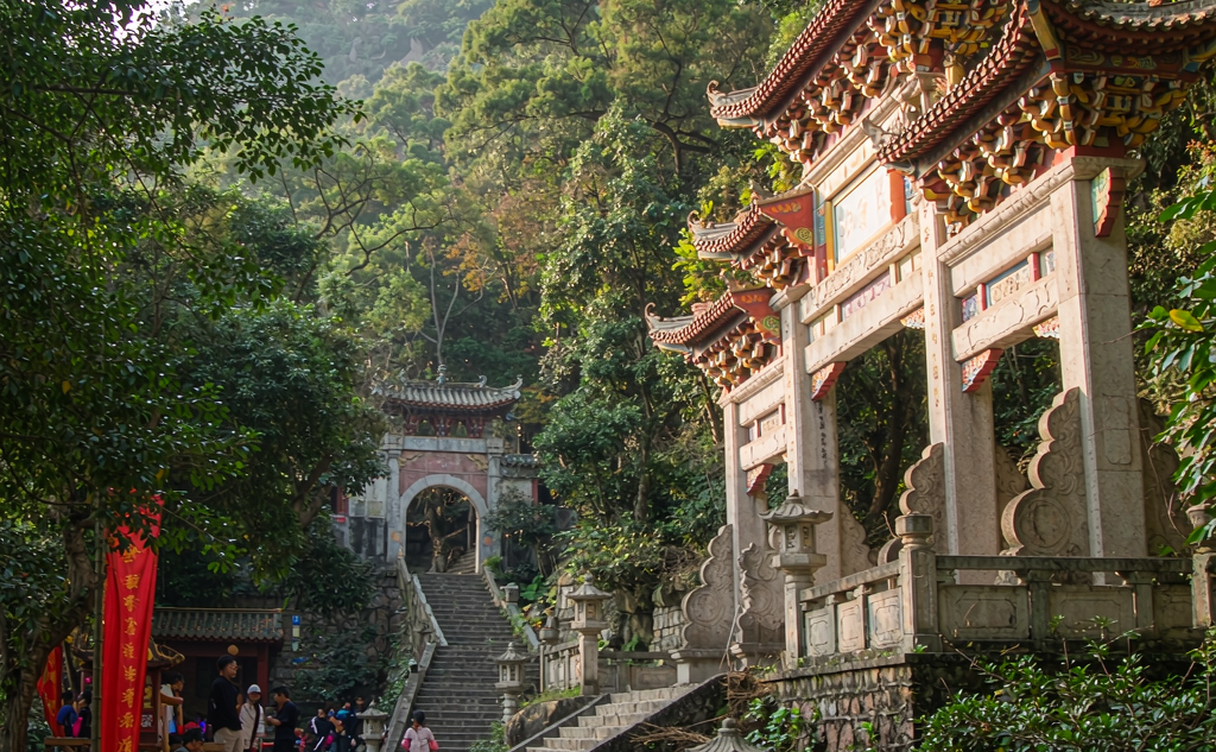 Carved demon statues and temple archways on Ming Mountain at Fengdu