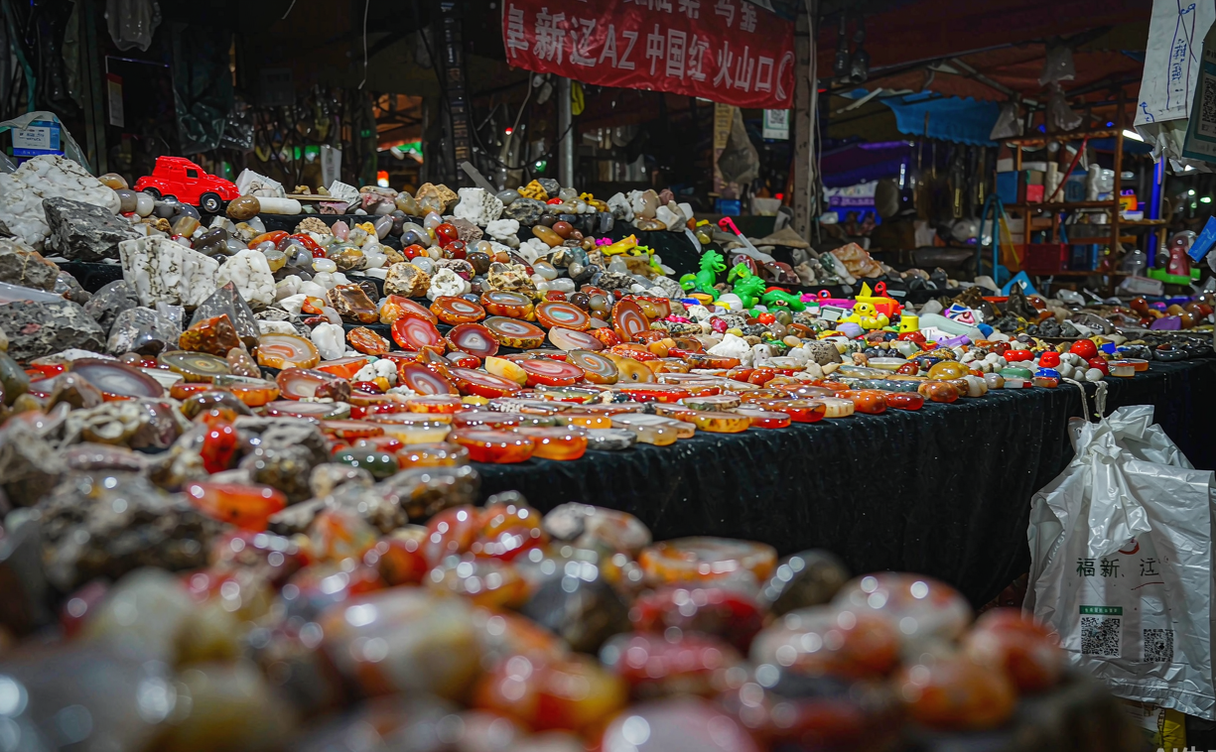 A bustling agate market with polished red and green stones in Fuxin, Liaoning, China