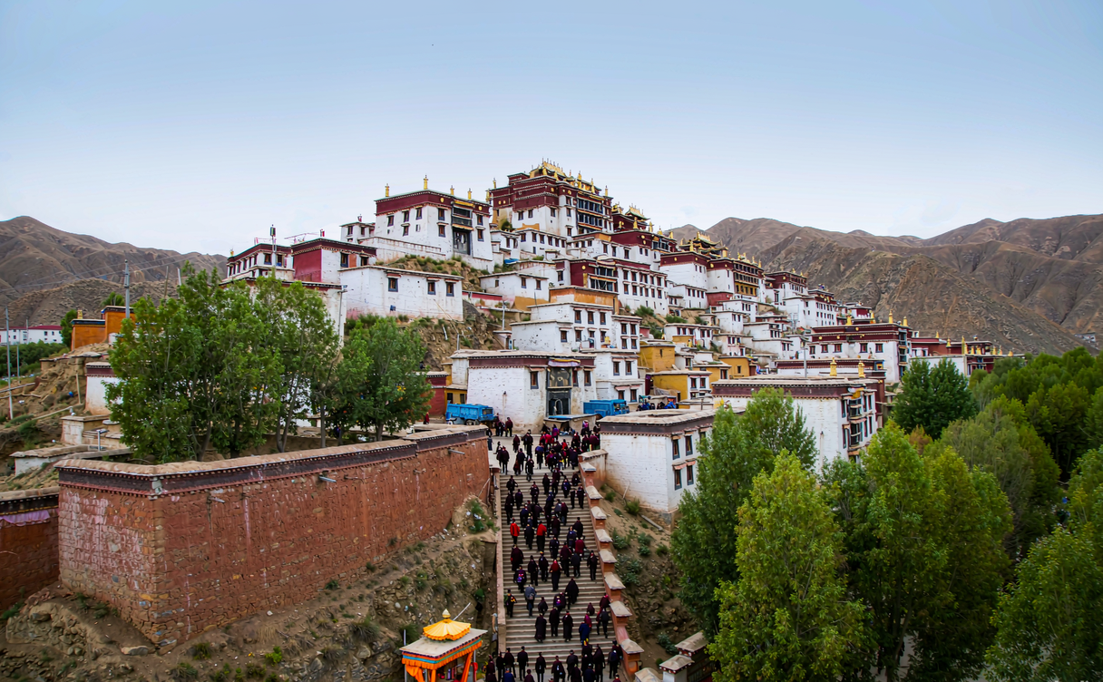 Pilgrims circumambulating the prayer-flag ridge path above Ganden Monastery, Tibet, China
