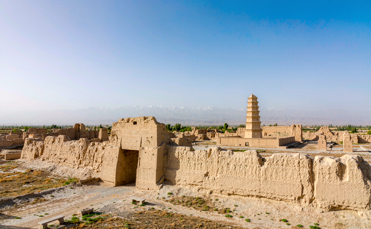 Crumbling earthen walls of Gaochang Ruins under a blue desert sky