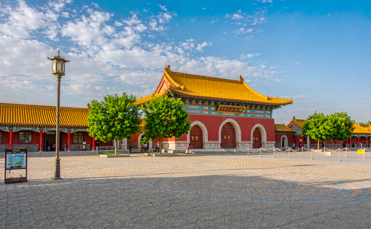 Three connected yurt-style blue and gold halls of the Genghis Khan Mausoleum on the Ordos grassland, China