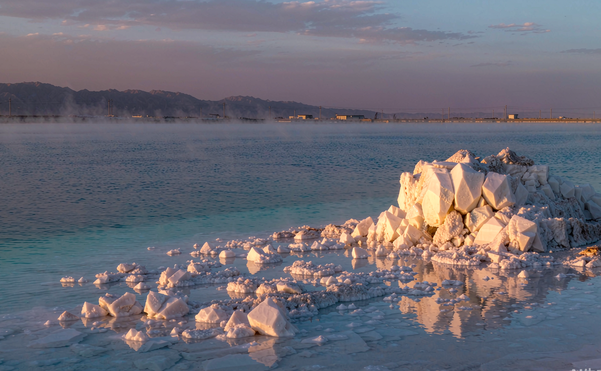 White salt crystal formations on a lake near Golmud, Qinghai, China at golden hour