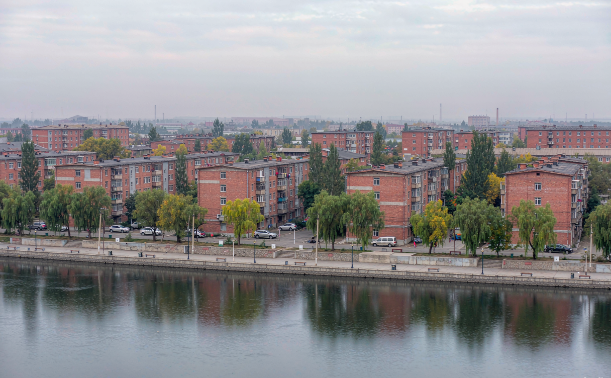 Hegang riverside coal city neighbourhood with red-brick blocks and chimneys