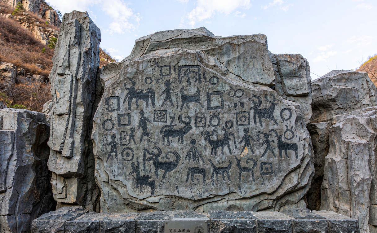 Ancient petroglyphs of faces and animals carved into Helan Mountain rock