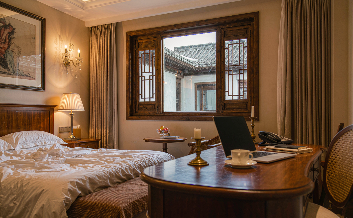 Courtyard suite at a Beijing hutong hotel with grey brick walls and central planting