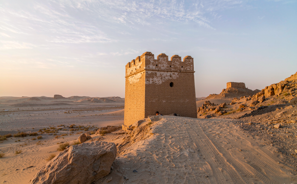 Jiayuguan Fort silhouette against Gobi desert sunset