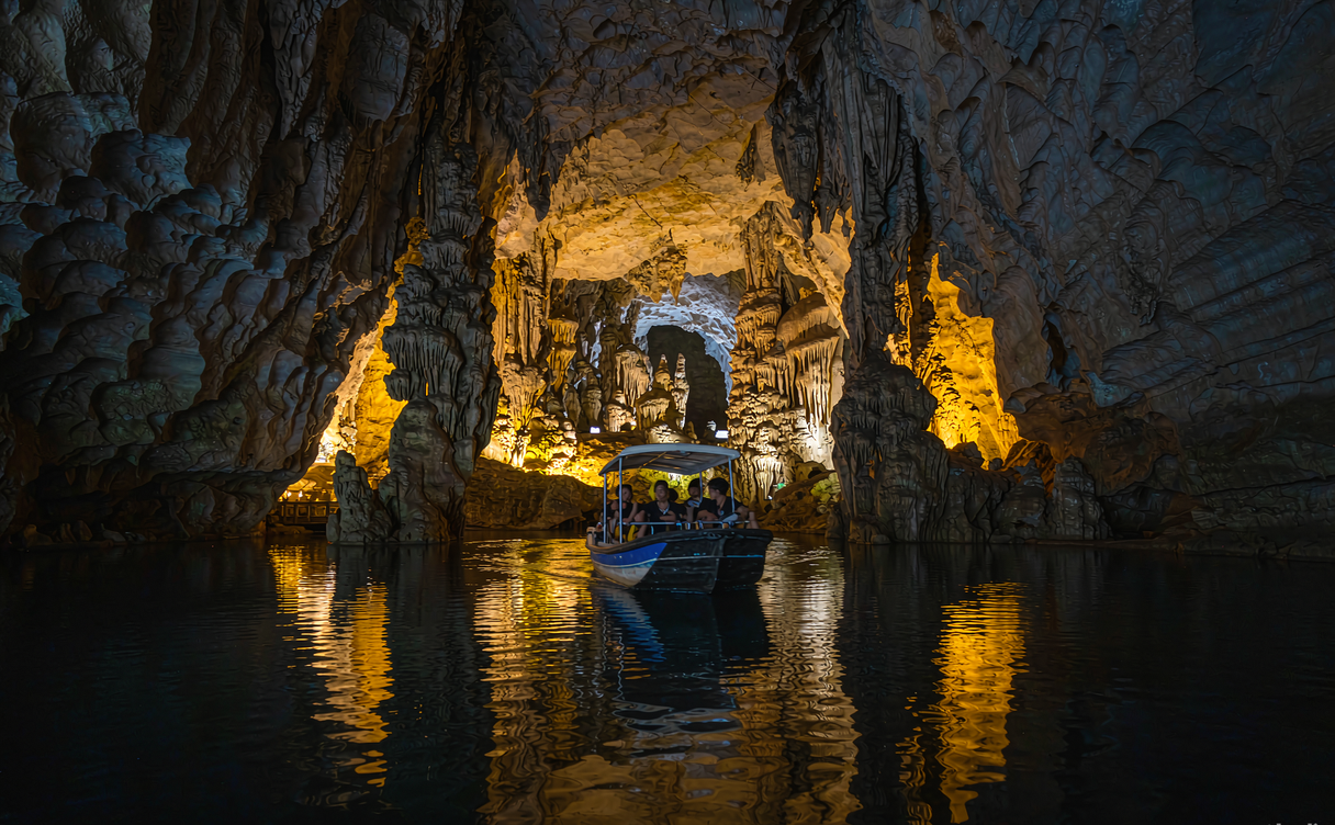 Electric boat on the underground river through the Jiuxiang karst stone forest