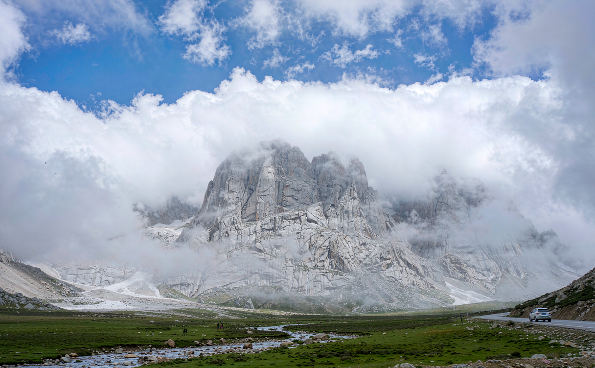 Rocky moraine and alpine meadow along the Golmud-Tibet road near Kunlun Mountain Pass