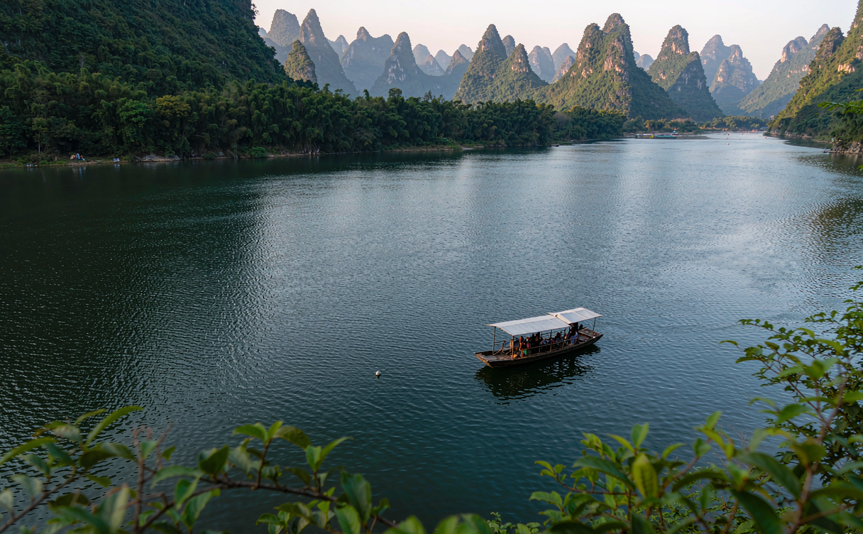 Limestone karst peaks mirrored in the still Li River near Xingping, Guilin, Guangxi