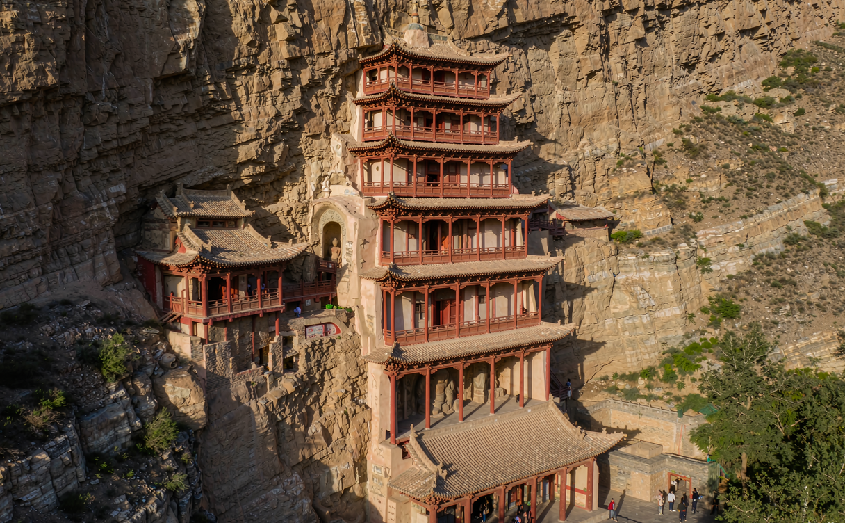 Mogao Caves cliff face at dusk along the Dachuan River near Dunhuang
